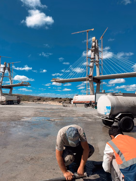 Vista de una obra de infraestructura vial con un tramo elevado y estructuras en construcción bajo cielo azul; imagen ilustrativa sobre inversión pública, sin identificar una obra específica.